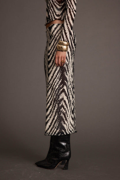 Lifestyle shot of the gold piece styled for day-to-night versatility.