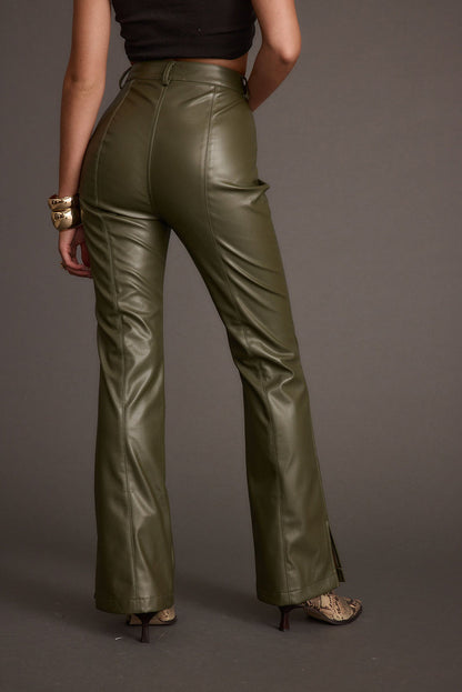 Back view of the olive vegan leather and leather flare pants showing the silhouette and fit.