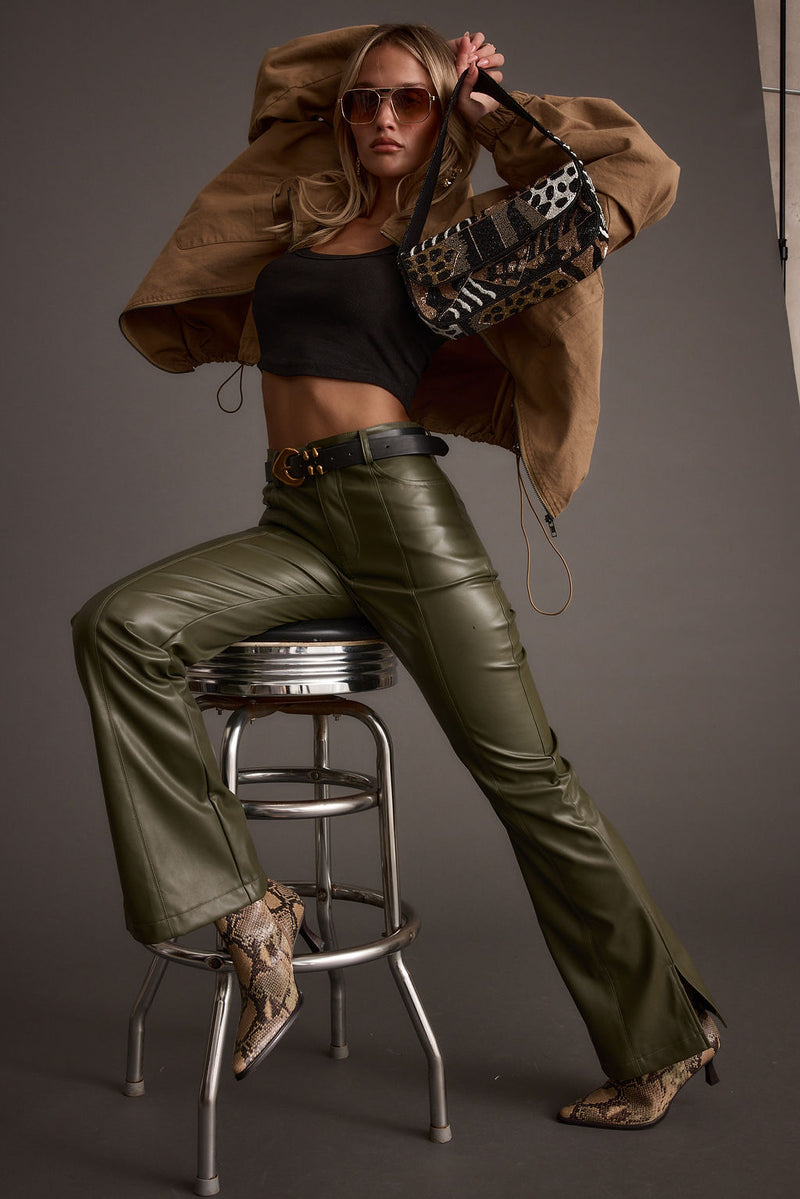 Ryland Olive Vegan Leather Flare Pants paired with complementary accessories for a polished look.