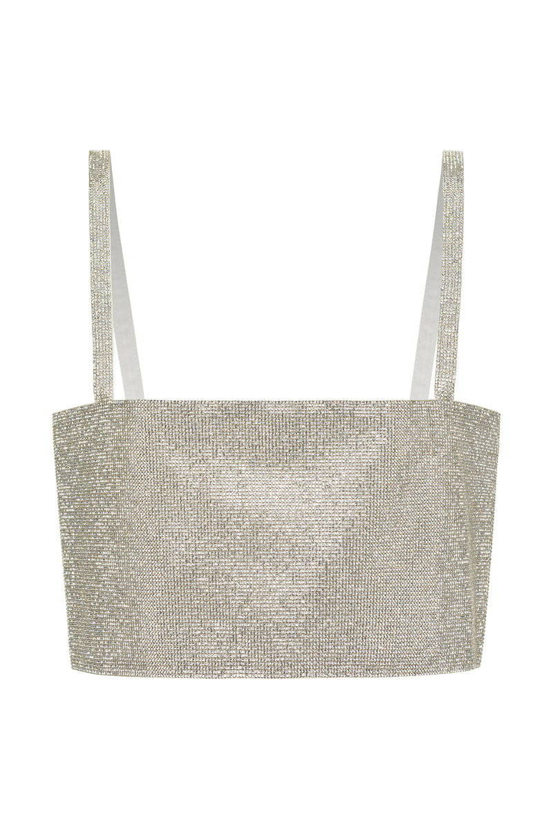 Lifestyle shot of the silver crop top styled for day-to-night versatility.