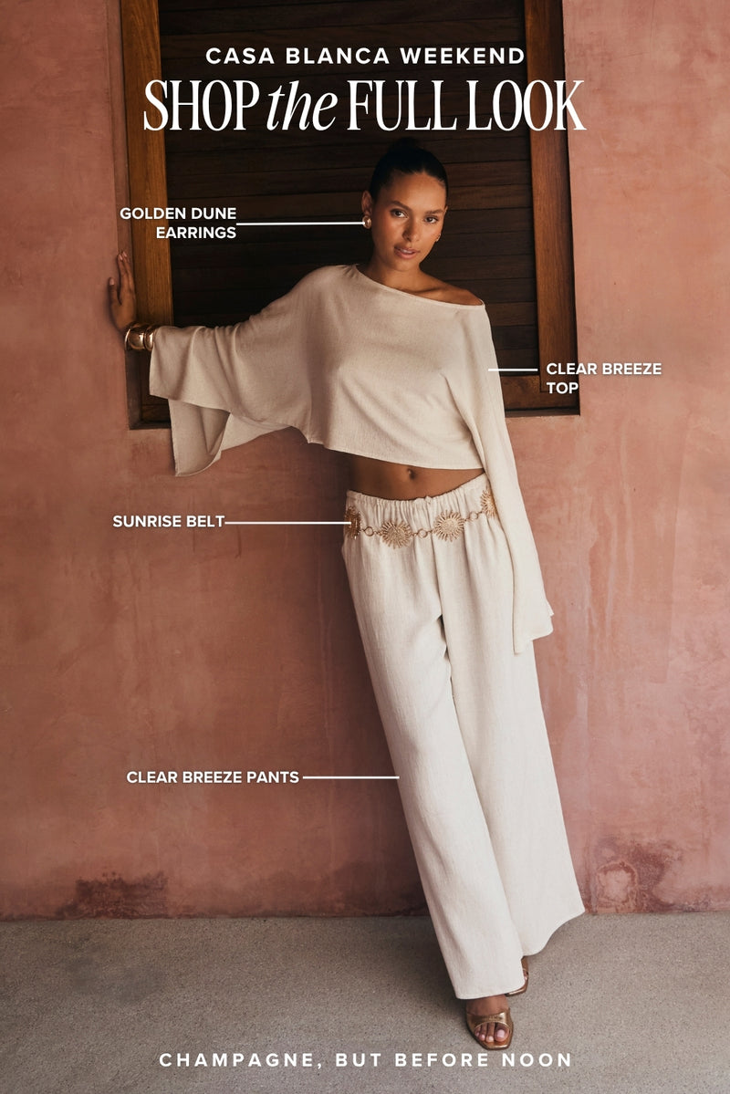 Casa Blanca Weekend women's resort outfit: cream off-shoulder top, wide-leg linen pants, gold belt.