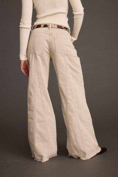 Back view of the beige jeans showing the silhouette and fit.