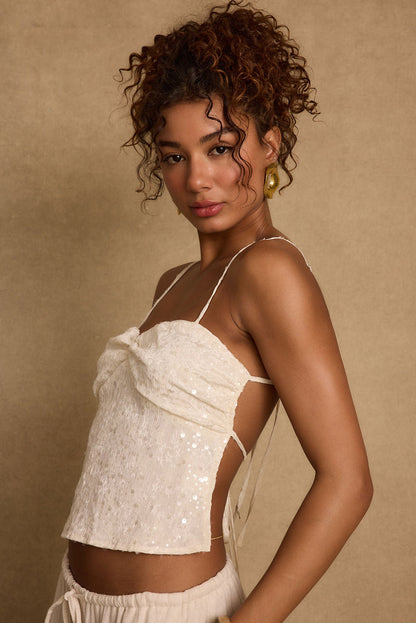Ivory sequin top with refined detailing and a flattering silhouette.