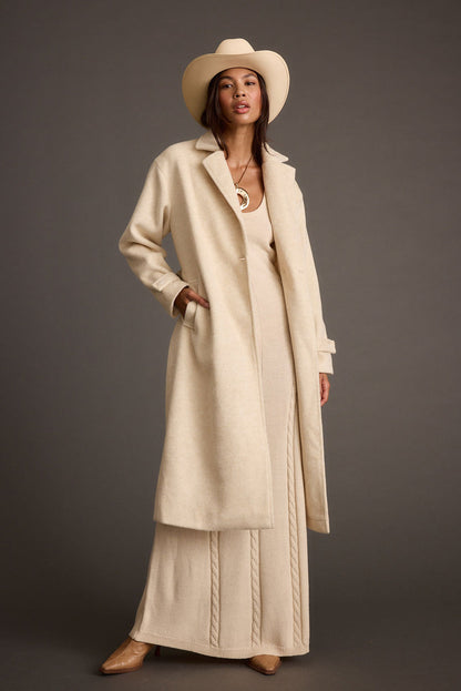 Back view of the ivory jacket showing the silhouette and fit.