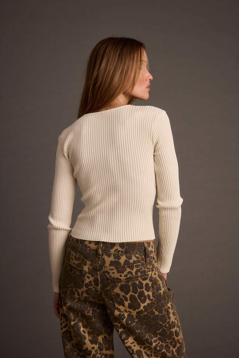 Back view of the ivory top showing the silhouette and fit.