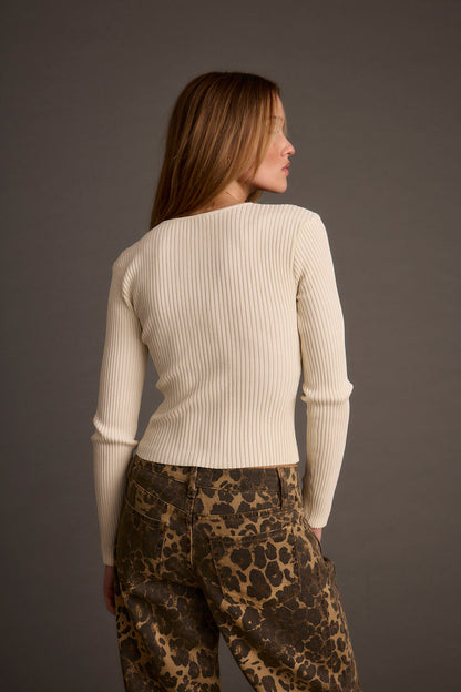 Back view of the ivory top showing the silhouette and fit.