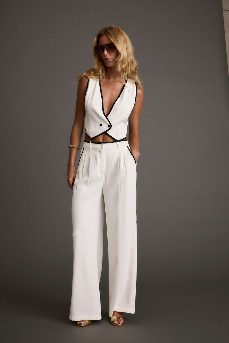 Full-length view of the white vest showing the drape and movement.