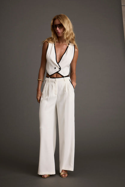 Full-length view of the white vest showing the drape and movement.