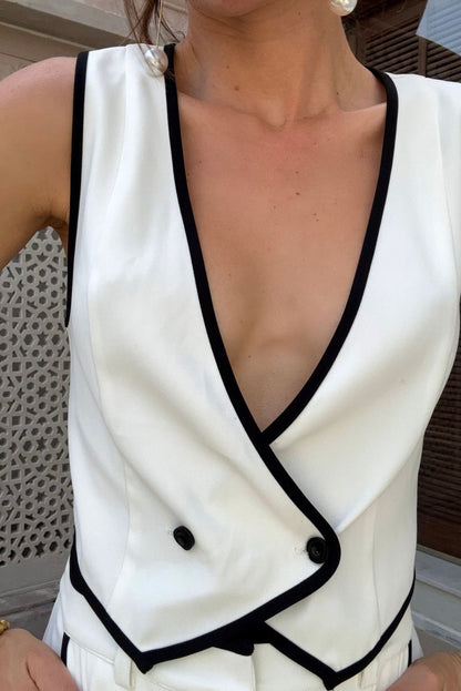 Lifestyle shot of the white vest styled for day-to-night versatility.