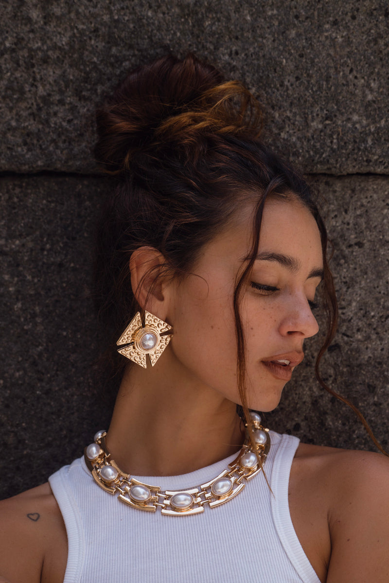 Gold earrings with refined detailing and an elegant finish.