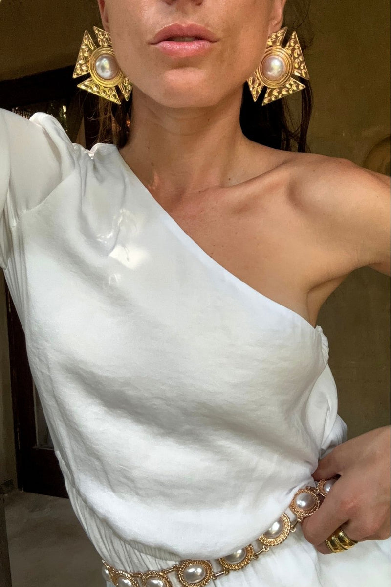 Solana Gold Statement Earrings shown from a different angle, highlighting the metalwork details.
