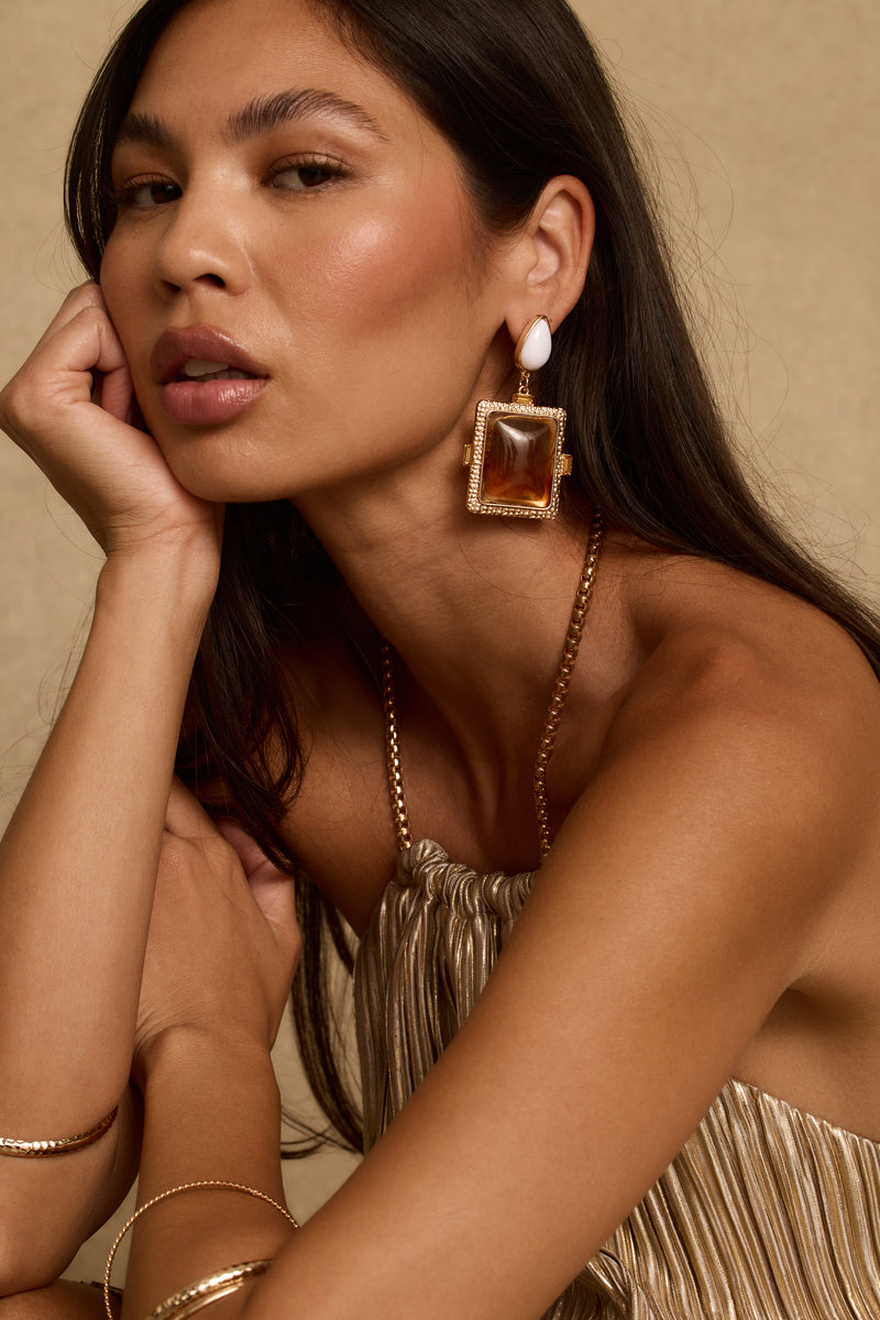 Soleil amber and white stone statement earring framed in gold, worn on-model.