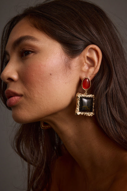 Close-up of the Soleil Statement Earrings showcasing the metalwork and pendant detail.