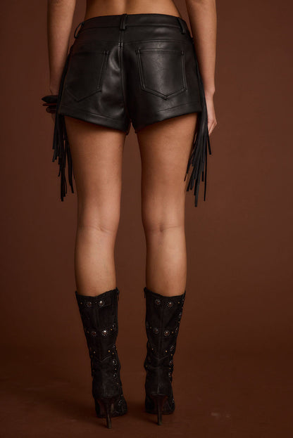 Full-length view of the black shorts showing the drape and movement.