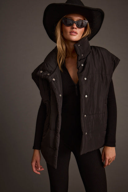 Black vest with refined detailing and a flattering silhouette.