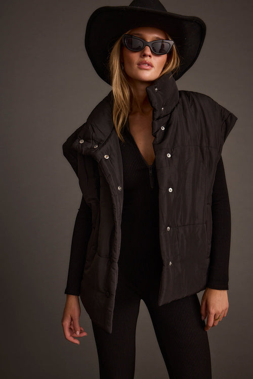 Black vest with refined detailing and a flattering silhouette.