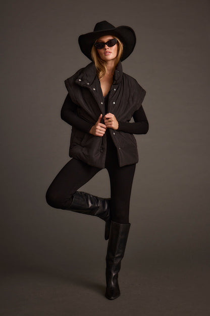 Back view of the black vest showing the silhouette and fit.
