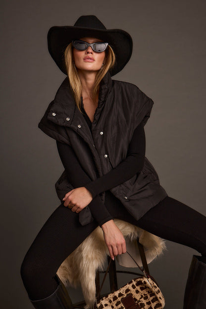Lifestyle shot of the black vest styled for day-to-night versatility.