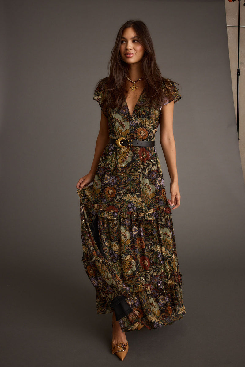 Full-length view of the floral maxi dress showing the drape and movement.