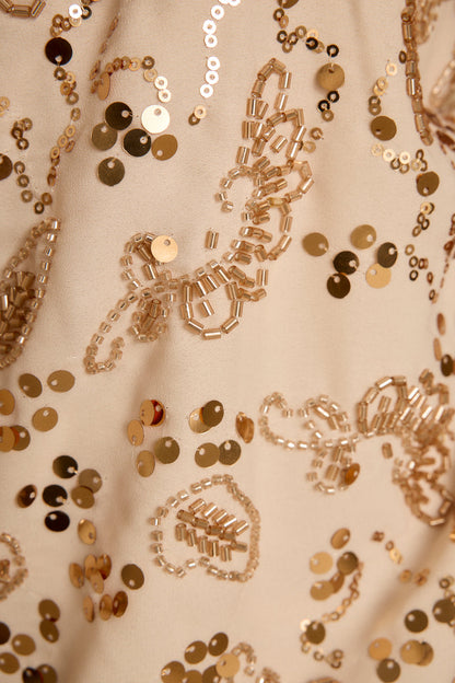 Full-length view of the ivory halter top showing the drape and movement.