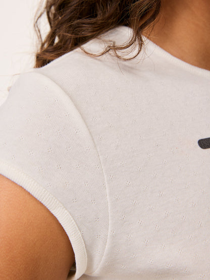 Close-up of the sleeve on the Fergus white printed T-shirt worn by a model