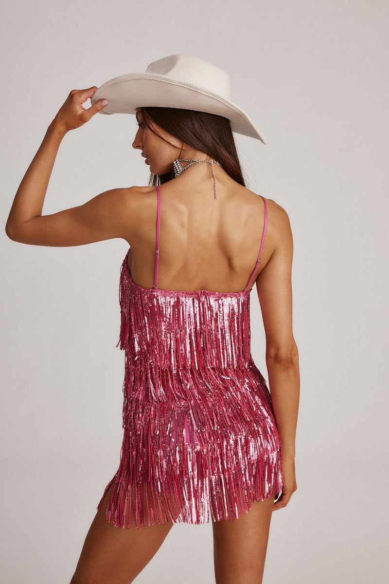 Back view of the pink sequin and fringe romper showing the silhouette and fit.
