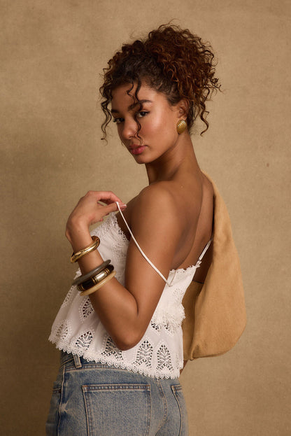 Tita White Eyelet Top shown in a complementary styling arrangement.