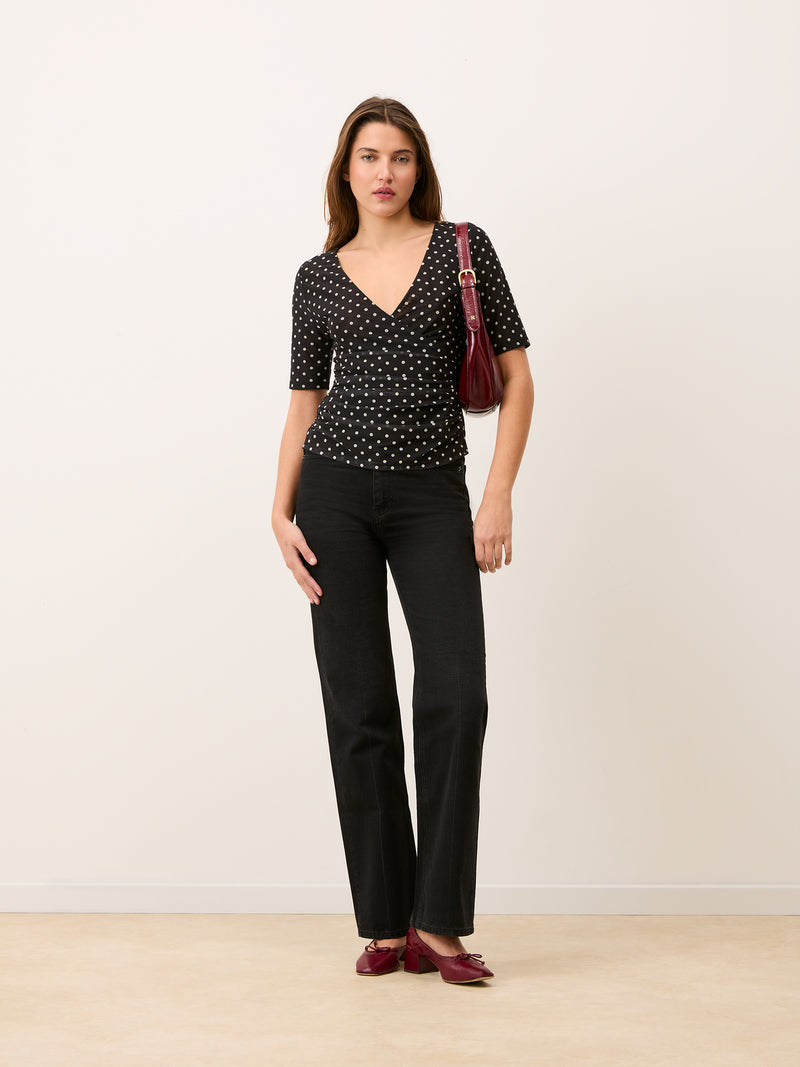 YURA black polka-dot mesh wrap effect top, side view by Rouje