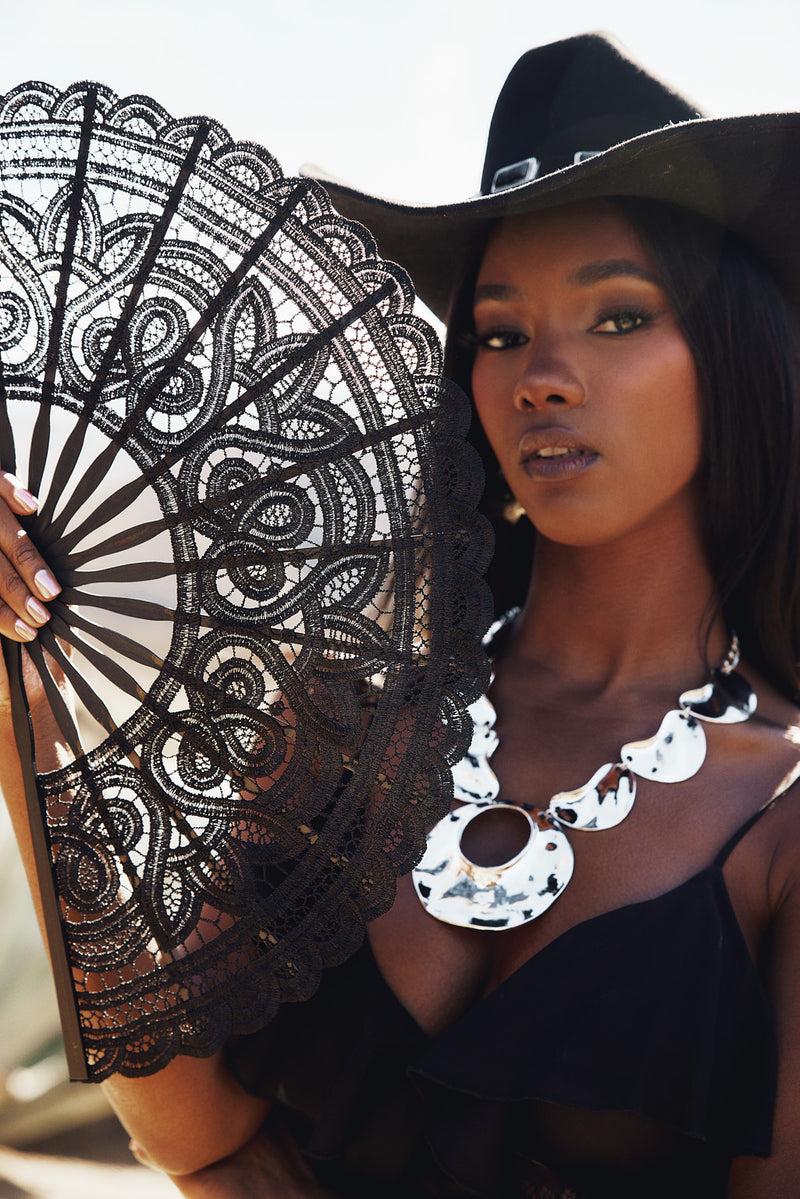 Close-up of the Unveiled Black Lace Fan showcasing the lace texture and craftsmanship.