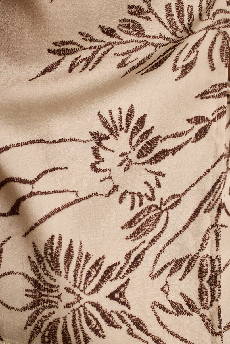 Close-up of the cream floral satin fabric with brown botanical print on the Verena top.