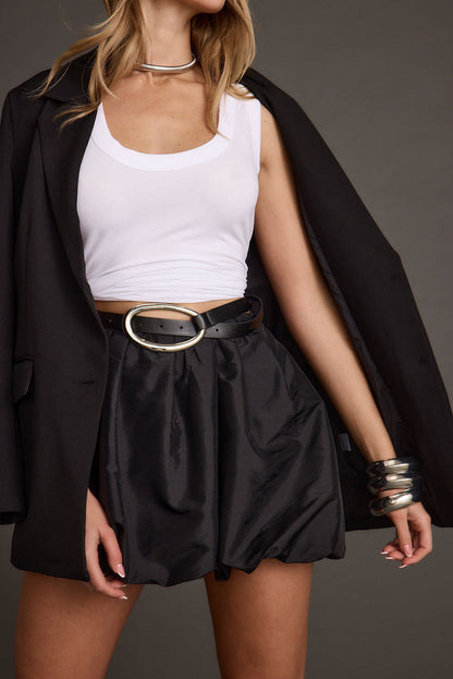 Back view of the black mini skirt showing the silhouette and fit.