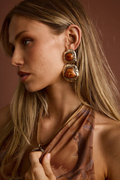 Wild Ember Gold Statement Earrings shown from a different angle, highlighting the metalwork details.